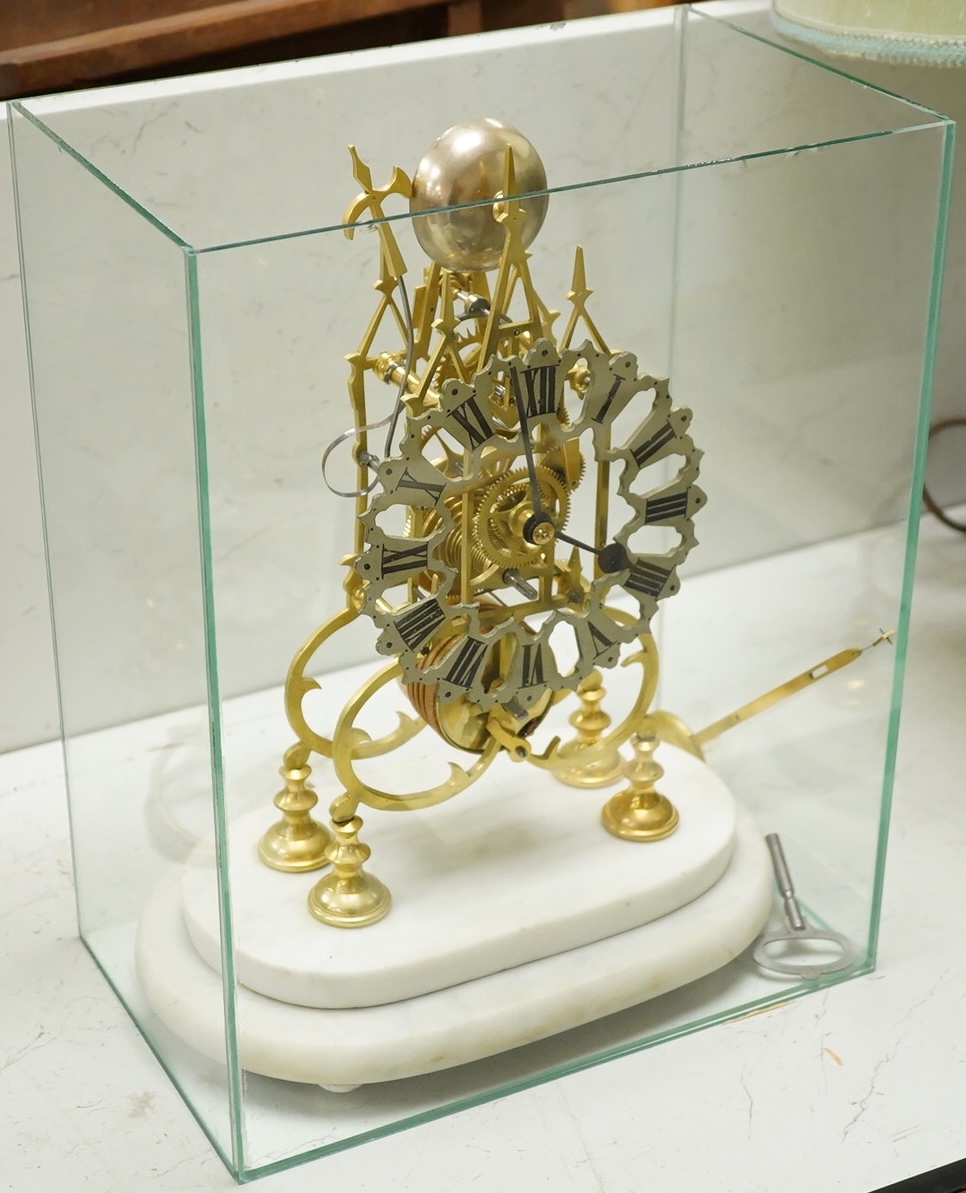A brass framed skeleton clock, with white marble stand, in glass case, case 39.5cm high